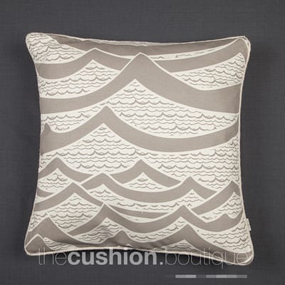 Cushion featuring handprinted waves with felt piping