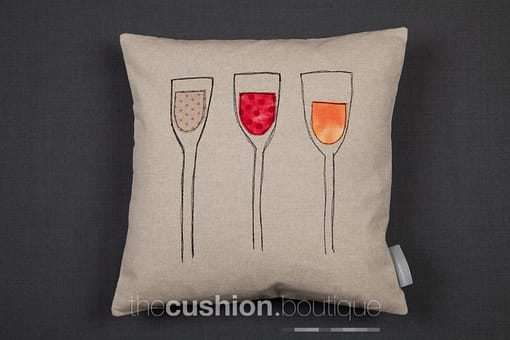 Handmade linen cushion featuring red, white & rosé fabric free machine embroidered wine glasses